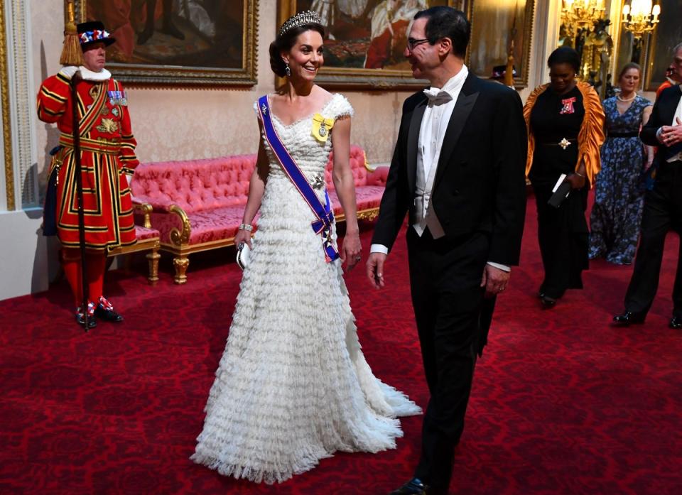 Catherine, the then-Duchess of Cambridge, walks with US Treasury Secretary Steven Mnuchin as they arrive in the East Gallery during the State Banquet held in the ballroom of Buckingham Palace in central London on June 3, 2019 (POOL/AFP via Getty Images)