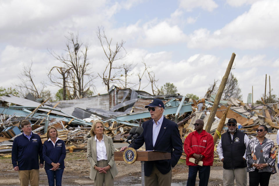 President Joe Biden speaks after surveying the damage in Rolling Fork, Miss., Friday, March 31, 2023, after a deadly tornado and severe storm moved through the area. From left, Mississippi Gov. Tate Reeves and his wife Elee Reeves, first lady Jill Biden, Biden, Rolling Fork Mayor Eldridge Walker, Rep. Bennie Thompson, D-Miss., and Housing and Urban Development Secretary Marcia Fudge. (AP Photo/Carolyn Kaster)