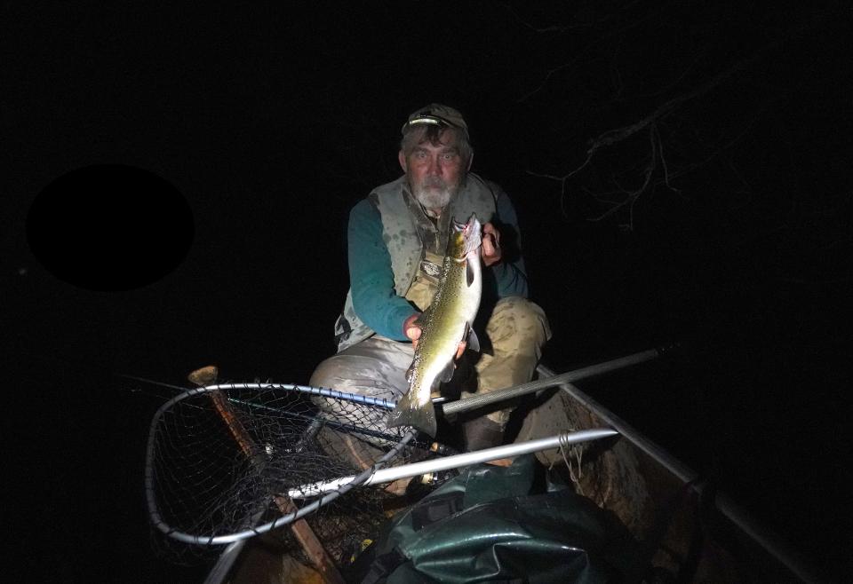 Ken Lundberg of Lake Nebagamon holds a 22-inch-long brown trout caught on while fishing after dark on the Bois Brule River.