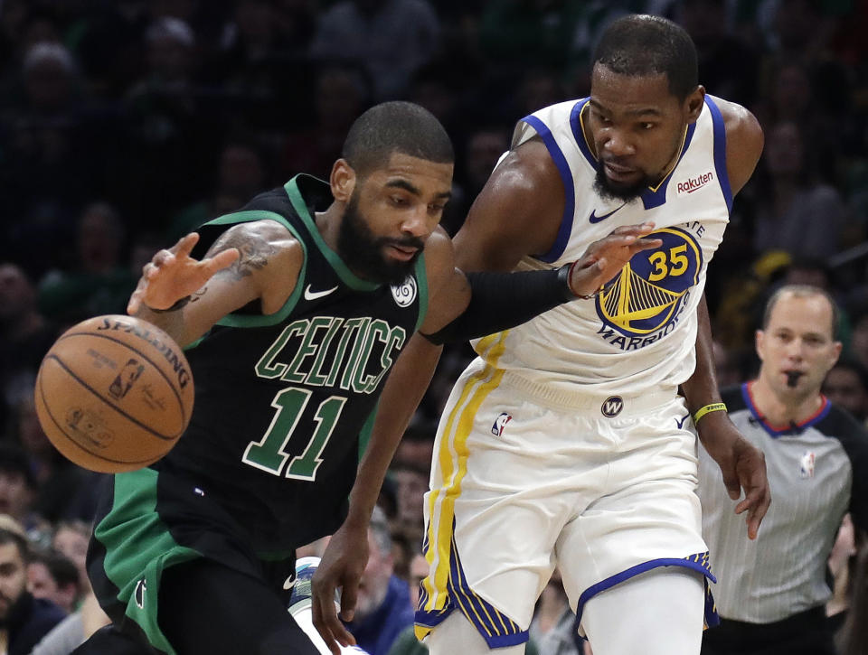 Boston Celtics guard Kyrie Irving (11) dribbles against Golden State Warriors forward Kevin Durant (35) in the first quarter of an NBA basketball game, Saturday, Jan. 26, 2019, in Boston. (AP Photo/Elise Amendola)