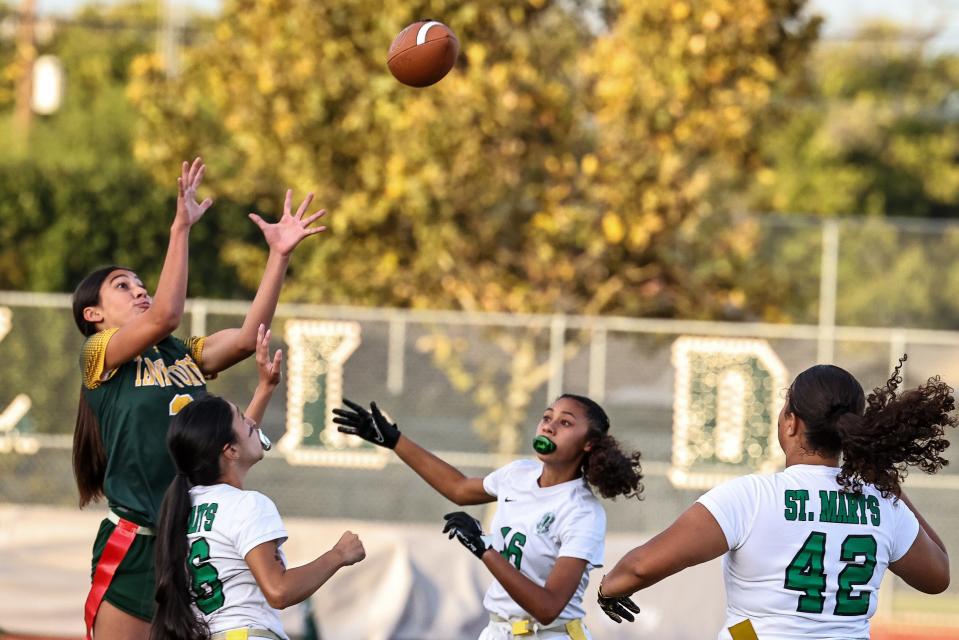Tracy Running Back Addison Perry goes up over the defense to catch a pass during a game between Tracy High and St.Mary’s High at Wayne Schneider Stadium in Tracy, Ca