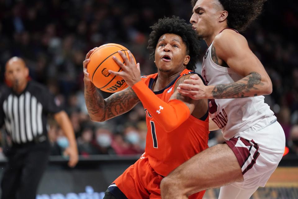 Auburn guard Wendell Green Jr. (1) drives to the hoop against South Carolina guard Devin Carter, right, during the first half of an NCAA college basketball game Tuesday, Jan. 4, 2022, in Columbia, S.C. (AP Photo/Sean Rayford)