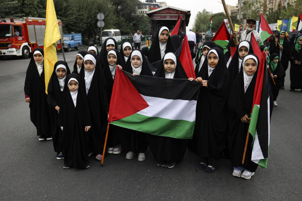 Iranian girls hold Palestinian flags as they attend a pro-Palestinian rally before the Friday prayer in Tehran, Iran, Friday, Oct. 13, 2023. (AP Photo)