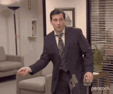 Michael slaps a stick string on Jim's desk to grab a paper