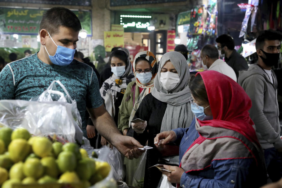 People wear protective face masks to help prevent the spread of the coronavirus in the Tajrish traditional bazaar in northern Tehran, Iran, Thursday, Oct. 15, 2020. Eight months after the pandemic first stormed Iran, pummeling its already weakened economy and sickening officials at the highest levels of its government, authorities appear just as helpless to prevent its spread. (AP Photo/Ebrahim Noroozi)