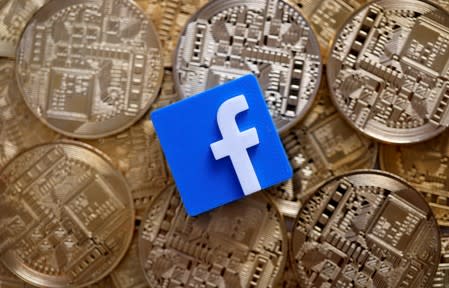 FILE PHOTO: Facebook logo is seen on representations of Bitcoin virtual currency in this illustration picture