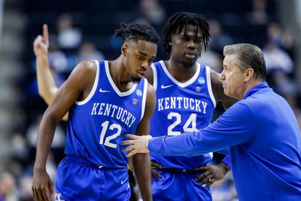 Kentucky head coach John Calipari talks with guard Antonio Reeves (12) and forward Chris Livingston (24) during the team’s second-round NCAA Tournament loss to Kansas State on March 19.