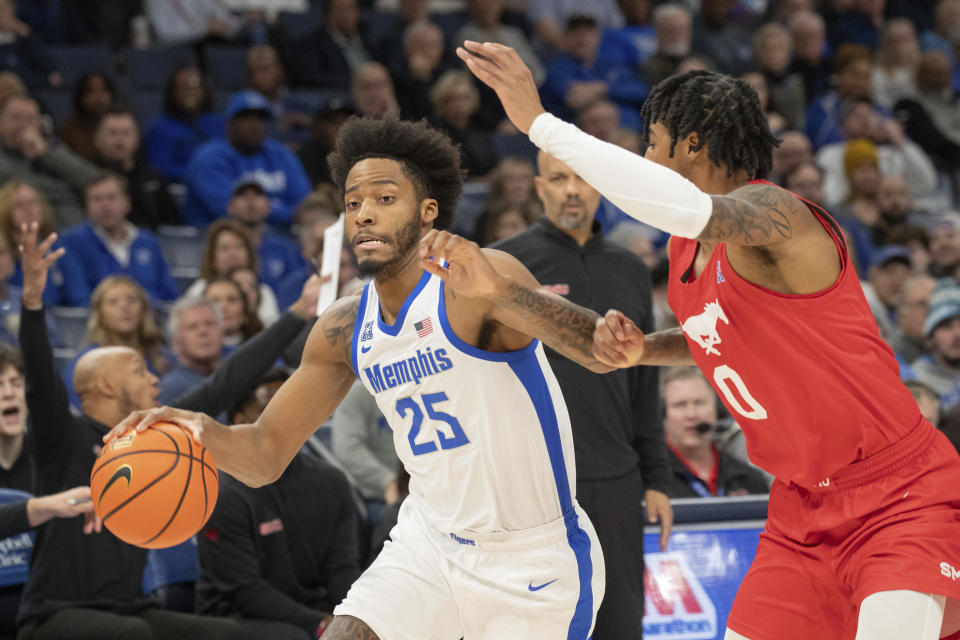 Memphis guard Jayden Hardaway (25) dribbles while defended by SMU guard B.J. Edwards (0) during the first half of an NCAA college basketball game Sunday, Jan. 7, 2024, in Memphis, Tenn. (AP Photo/Nikki Boertman)