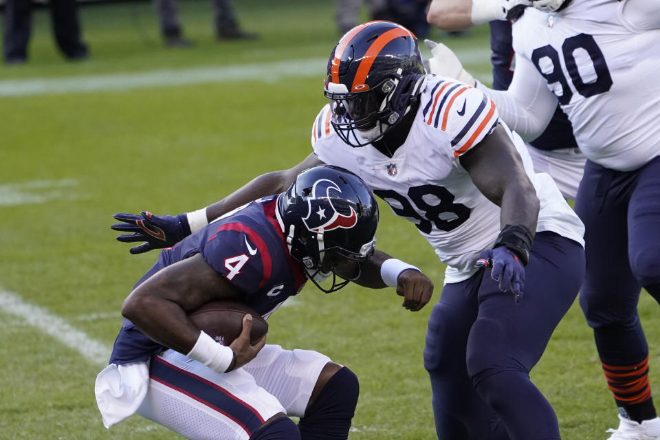 Chicago Bears' Bilal Nichols (98) sacks Houston Texans quarterback Deshaun Watson (4) during the first half of an NFL football game, Sunday, Dec. 13, 2020, in Chicago. (AP Photo/Charles Rex Arbogast)