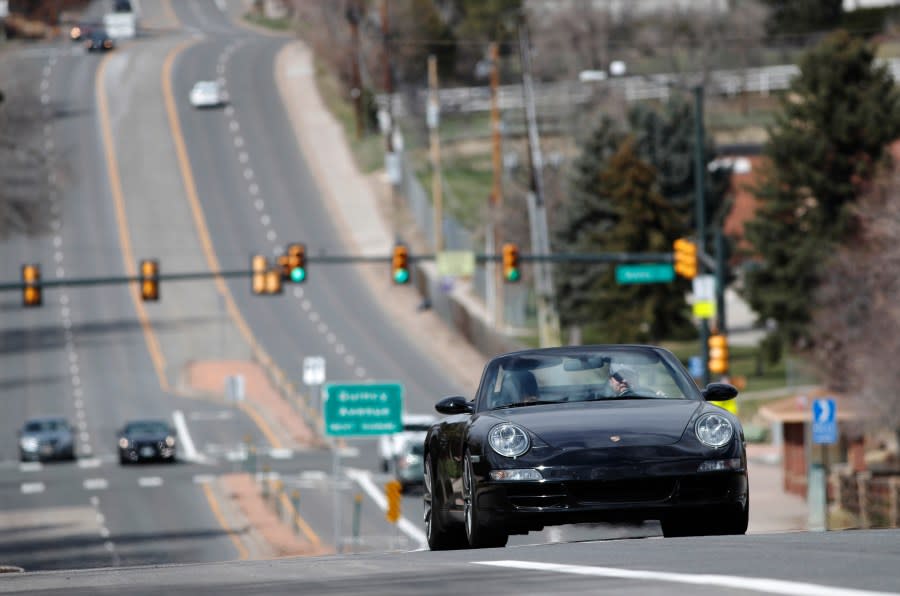 A motorist guides his Porsche convertible along South University Boulevard