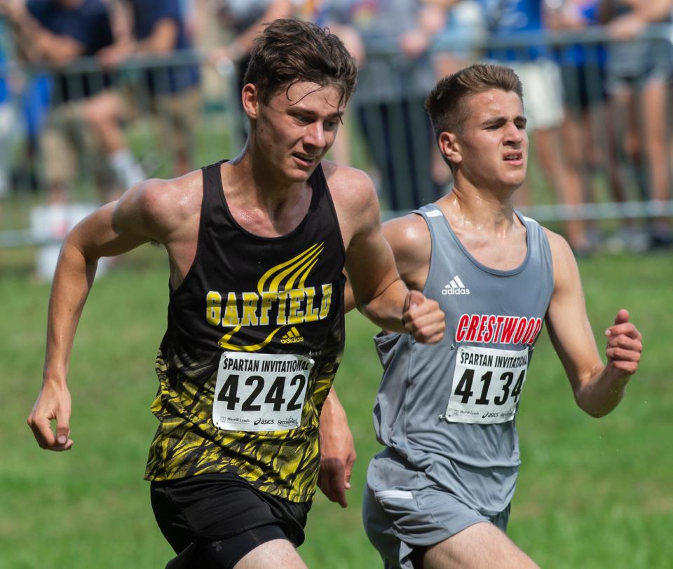 Kyle Schaefer of Garfield and Schweickert Augie of Crestwood race at Saturday's Spartan Invitational in Boardman.