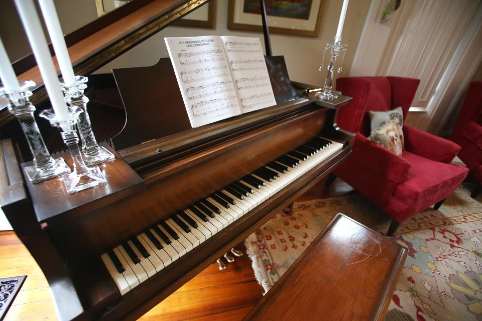 A piano from the 1940’s sits in the living room. It is a place decorated for Christmas in Glenna Hanks Wade’s home on Main Street in Madison, Indiana. 
Oct. 30, 2023