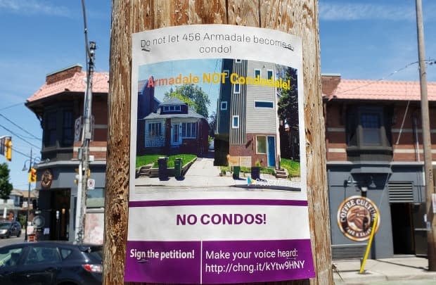 A Toronto poster objecting to densification of an urban neighbourhood. Real estate experts say buying to rent in the big city is seldom profitable, meaning the flats are usually sold to separate buyers.  (Don Pittis/CBC - image credit)