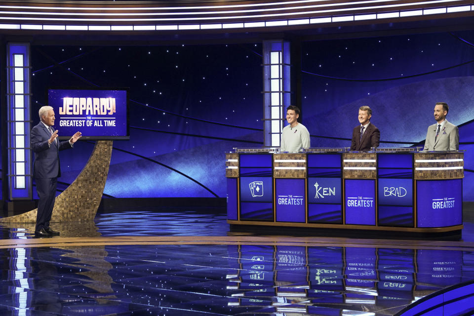 In this image released by ABC, host Alex Trebec, left, appear with contestants, James Holzhauer, center, Ken Jennings and Brad Rutter, right, on the set of "Jeopardy! The Greatest of All Time," in Los Angeles. The all-time top “Jeopardy!” money winners; Rutter, Jennings and Holzhauer, will compete in a rare prime-time edition of the TV quiz show which will air on consecutive nights beginning 8 p.m. EDT Tuesday. (Eric McCandless/ABC via AP)