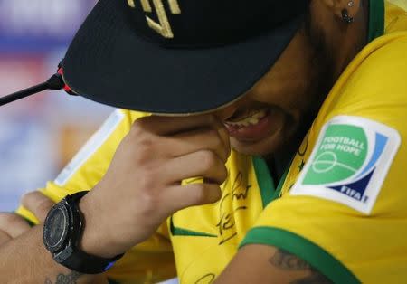 Injured Brazilian national soccer team player Neymar cries during a news conference in Teresopolis, near Rio de Janeiro, July 10, 2014. REUTERS/Marcelo Regua