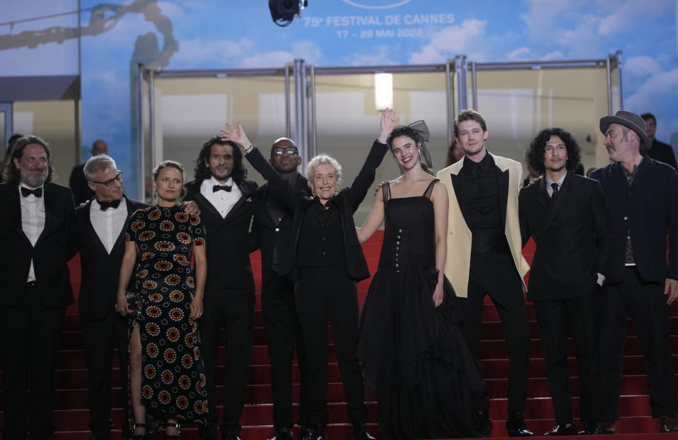 Producer Olivier Delbosc, Hester Ruoff, from third left, Nick Romano, director Claire Denis, sixth from left, Margaret Qualley, Joe Alwyn, Danny Ramirez, and Stuart A. Staples pose for photographers upon arrival at the premiere of the film 'Stars at Noon' at the 75th international film festival, Cannes, southern France, Wednesday, May 25, 2022. (AP Photo/Petros Giannakouris)