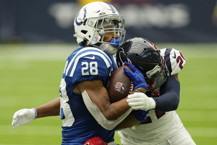Indianapolis Colts running back Jonathan Taylor (28) gets hit by Houston Texans cornerback Steven Nelson (21) after a catch during the second half of an NFL football game Sunday, Sept. 11, 2022, in Houston. (AP Photo/David J. Phillip)