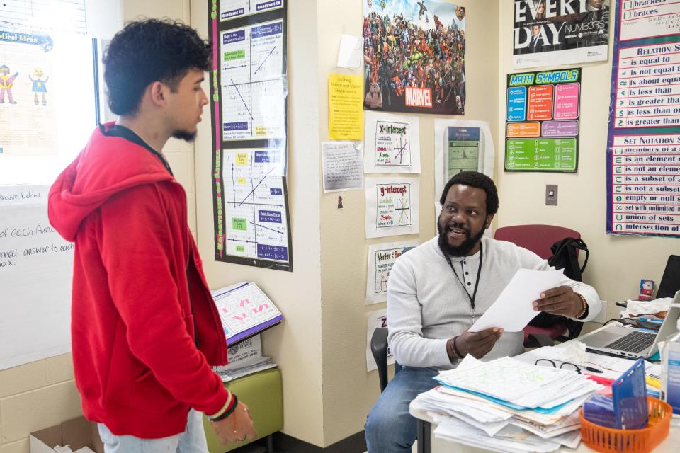 Senior Matthew Gonzalez turns in a math project to algebra teacher Rayton Kamheuka during a voluntary half-day at H.M. King Early College High School on Friday, Feb. 9, 2024, in Kingsville, Texas.