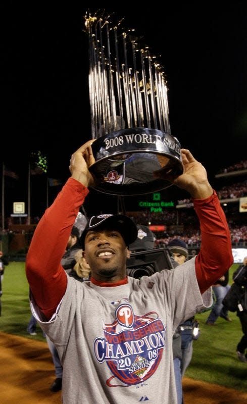 Philadelphia Phillies' Jimmy Rollins holds up the trophy after Game 5 of the 2008 World Series. Rollins is a special advisor to the president of baseball operations for the Phillies. David J. Phillip/AP