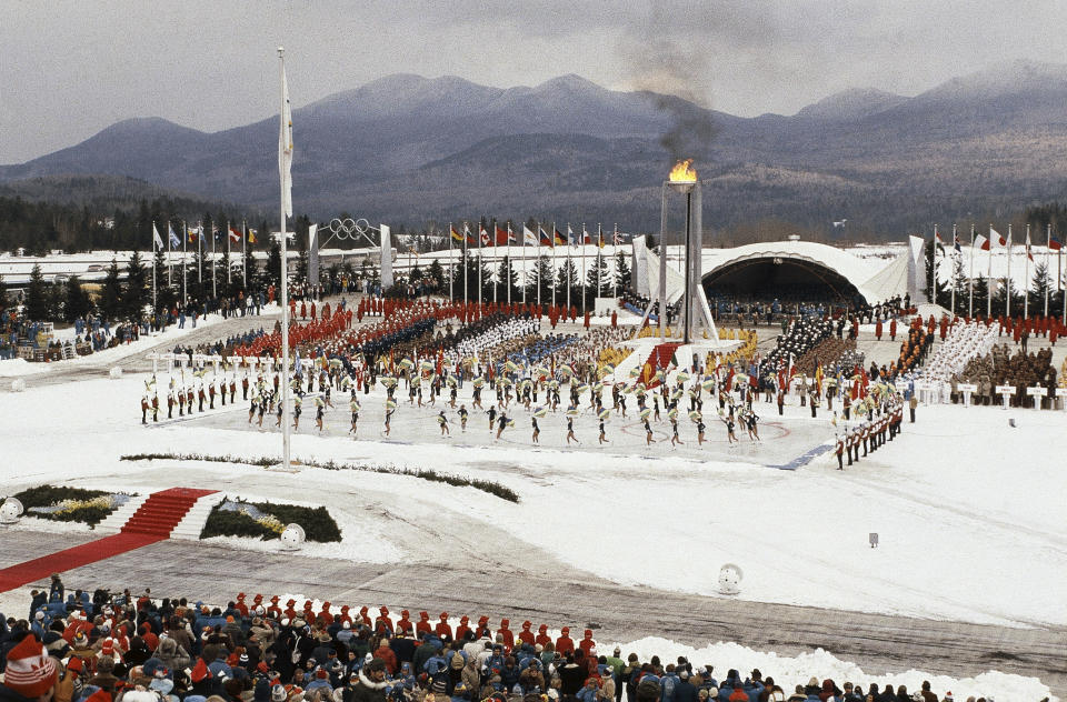 FILE - This Feb. 13, 1980, file photo shows the opening ceremony of the XIII Winter Olympics in Lake Placid, N.Y. Lake Placid is celebrating the 40th anniversary of the Winter Olympics that were held in the Adirondack Mountain village. It's an important moment for Lake Placid, which will host the 2023 Winter World University Games, and a reminder of its place as one of only three resort towns to host two Winter Olympiads.(AP Photo)