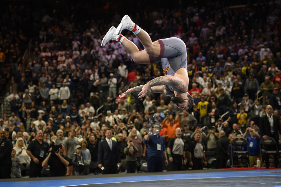 Minnesota's Gable Steveson celebrates with a backflip after defeating Arizona State 's Cohlton Schultz during their heavyweight match in the finals of the NCAA Division I wrestling championships in Detroit, Saturday, March 19, 2022. (Andy Morrison/Detroit News via AP)