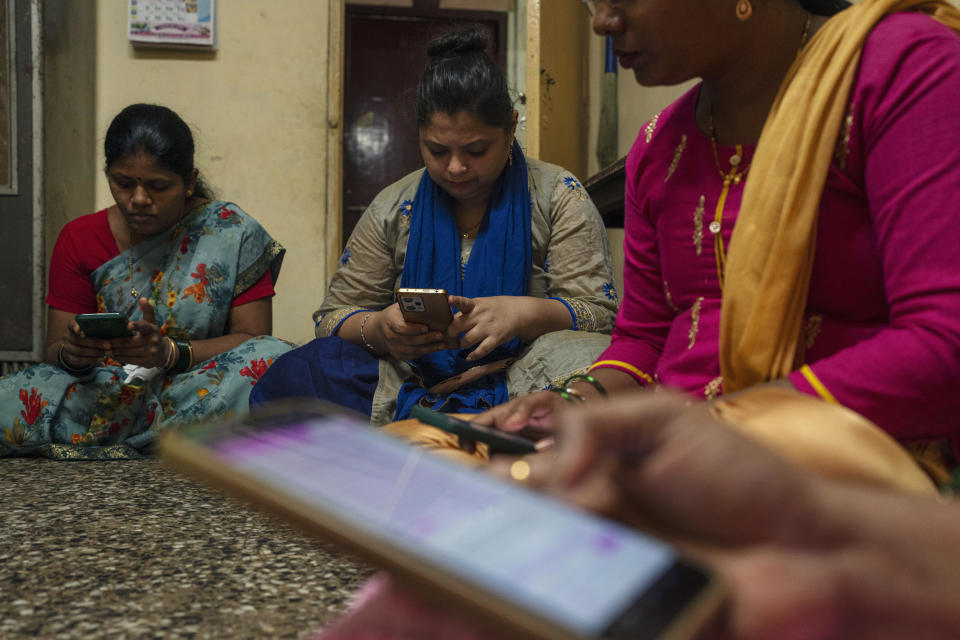 Women learn to use a chatbot powered by artificial intelligence developed by Myna Mahila Foundation at the local women's organization’s office in Mumbai, India, Feb. 1, 2024. The chatbot, currently a pilot project, represents what many hope will be part of the impact of AI on health care around the globe: to deliver accurate medical information in personalized responses that can reach many more people than in-person clinics or trained medical workers. (AP Photo/Rafiq Maqbool)