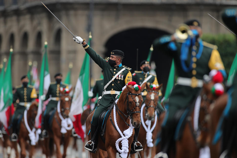 VARIOUS CITIES, MEXICO - SEPTEMBER 16: Soldiers salute towards President Andrés Manuel López Obrador during the Independence Day military parade at Zocalo Square on September 16, 2020 in Various Cities, Mexico. This year El Zocalo remains closed for general public due to coronavirus restrictions. Every September 16 Mexico celebrates the beginning of the revolution uprising of 1810. (Photo by Hector Vivas/Getty Images)