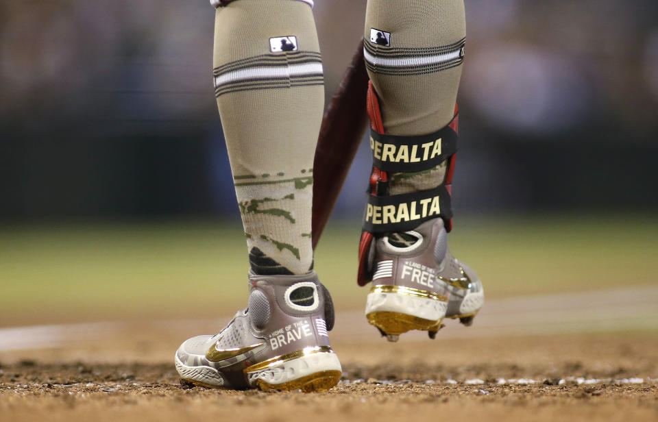 Arizona Diamondbacks' David Peralta honors military members with his cleats as he prepares to bat against the Washington Nationals during the fourth inning of a baseball game Friday, May 14, 2021, in Phoenix. (AP Photo/Darryl Webb)