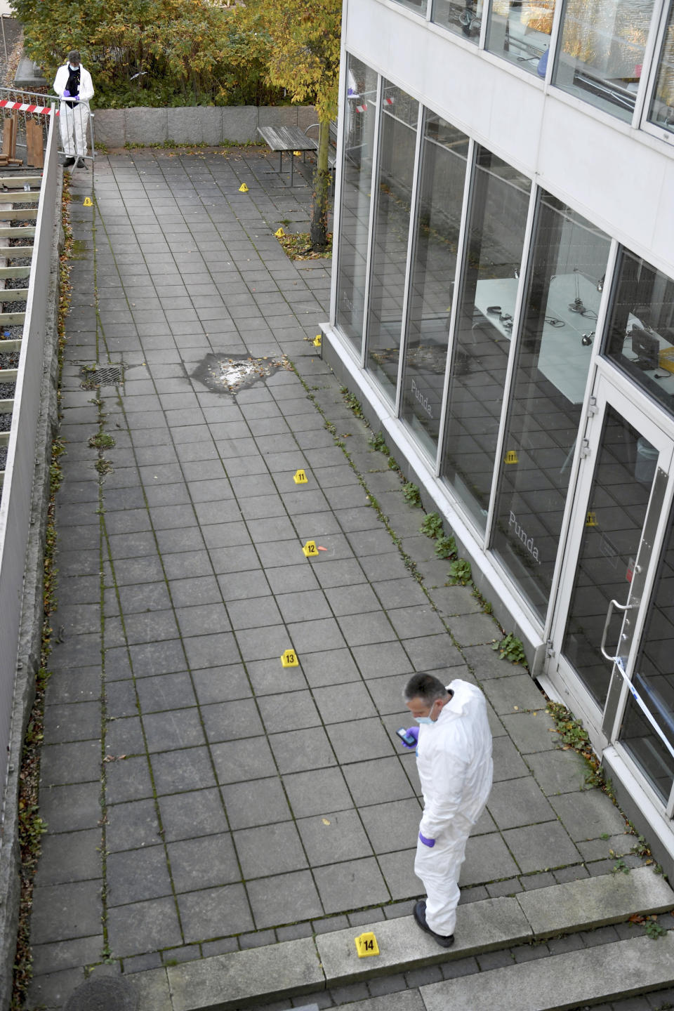 Forensic police work on the site where Swedish rapper Einar was shot to death, in Hammarby Sjostad district in Stockholm, Friday, Oct. 22, 2021. An award-winning 19-year-old Swedish rapper was shot to death in southern Stockholm in an incident that media reports on Friday suggested could be gang-related. The rapper Einar was struck by several bullets in the Hammarby suburb south of central Stockholm and died on the spot late Thursday, police spokesman Ola Osterling told the Swedish news agency TT. (Henrik Montgomery/TT via AP)