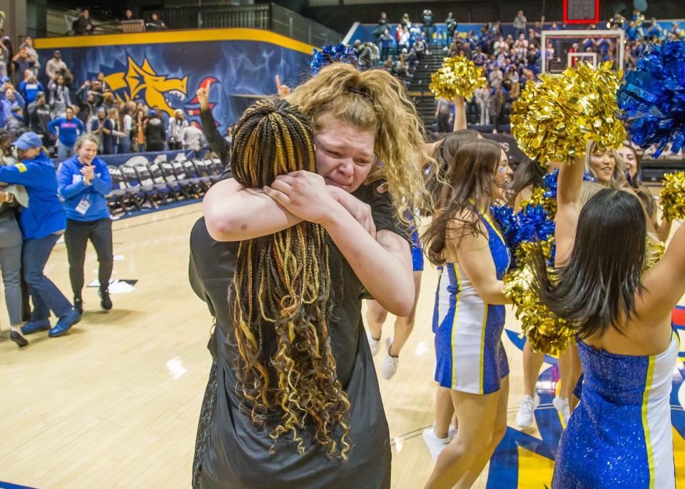 Lizzie Oleary celebrates Blue Hens' CAA basketball title.