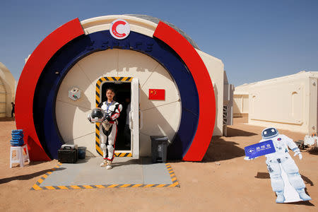 A staff member poses in a mock space suit at the C-Space Project Mars simulation base in the Gobi Desert outside Jinchang, Gansu Province, China, April 17, 2019. REUTERS/Thomas Peter