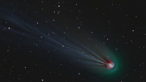  A comet with a swirl of light around its head. 