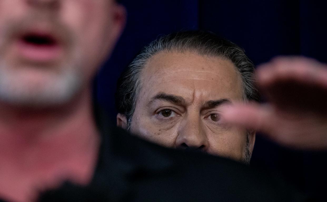 Arizona Attorney General Mark Brnovich (right) looks on while Bryan Willington (United Phoenix Firefighters Local 493) answers questions during a press conference on Nov. 22, 2021, at the Attorney General's Office in Phoenix.