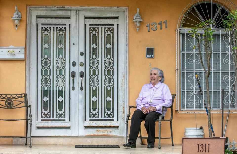 Ana Lazara Rodriguez sits outside her home in Miami on Tuesday, Feb. 23, 2021. She is an 82-year-old survivor of a Castro prison at risk of being evicted.