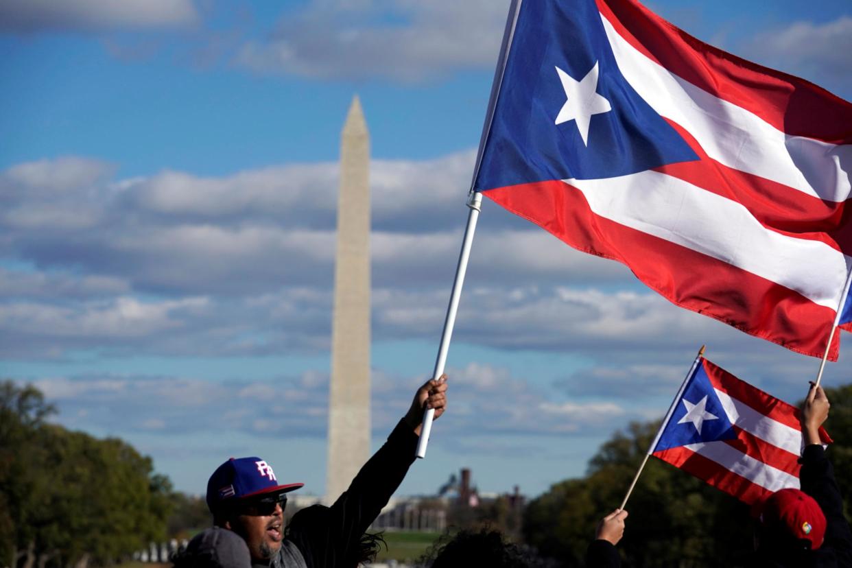 People wave Puerto Rican flags at the Unity March to highlight the ongoing humanitarian and natural disaster crisis in Puerto Rico, at the Lincoln Memorial in Washington, U.S., November 19, 2017: REUTERS