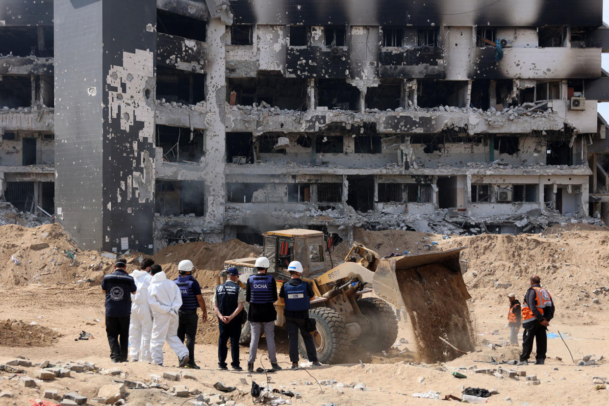 A United Nations (UN) team visit as Palestinian civil defence recover human remains the grounds of Al-Shifa hospital in Gaza (AFP- Getty Images)