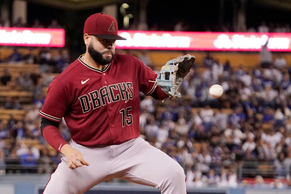 Arizona Diamondbacks third baseman Emmanuel Rivera fields a ball hit by Los Angeles Dodgers' Mookie Betts during the fifth inning of a baseball game Tuesday, Sept. 20, 2022, in Los Angeles. Betts was thrown out at first on the play. (AP Photo/Mark J. Terrill)