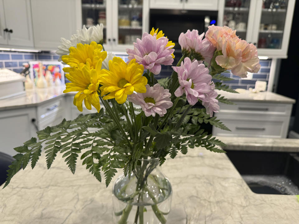 This May 2, 2024 image shows an arrangement of flowers, their stems trimmed and lower foliage removed, in a clean vase filled with water. (AP Photo/Sallee Ann Harrison)