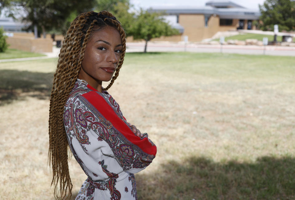 Tiera Brown stands outside Montbello High School in northeast Denver on June 22, 2020 Former Denver student Brown, 28, wonders if there would be more fellow Black students in her University of Denver law class if they had been treated with more understanding earlier in their educations. (AP Photo/David Zalubowski)