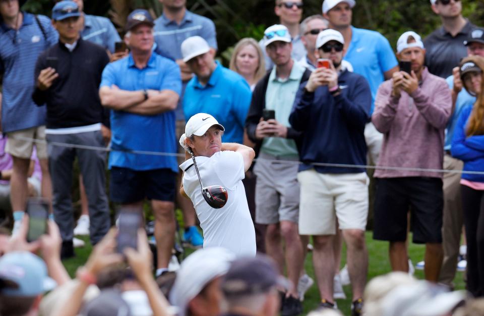 As the crowd looks on, Rory McIlroy hits his tee shot on hole 15 during The Players Championship's first round in 2023. The 2019 Players champion has missed two of three cuts at the tournament since.