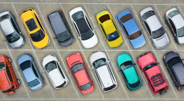 assortment of cars in a parking lot representing GETR stock.