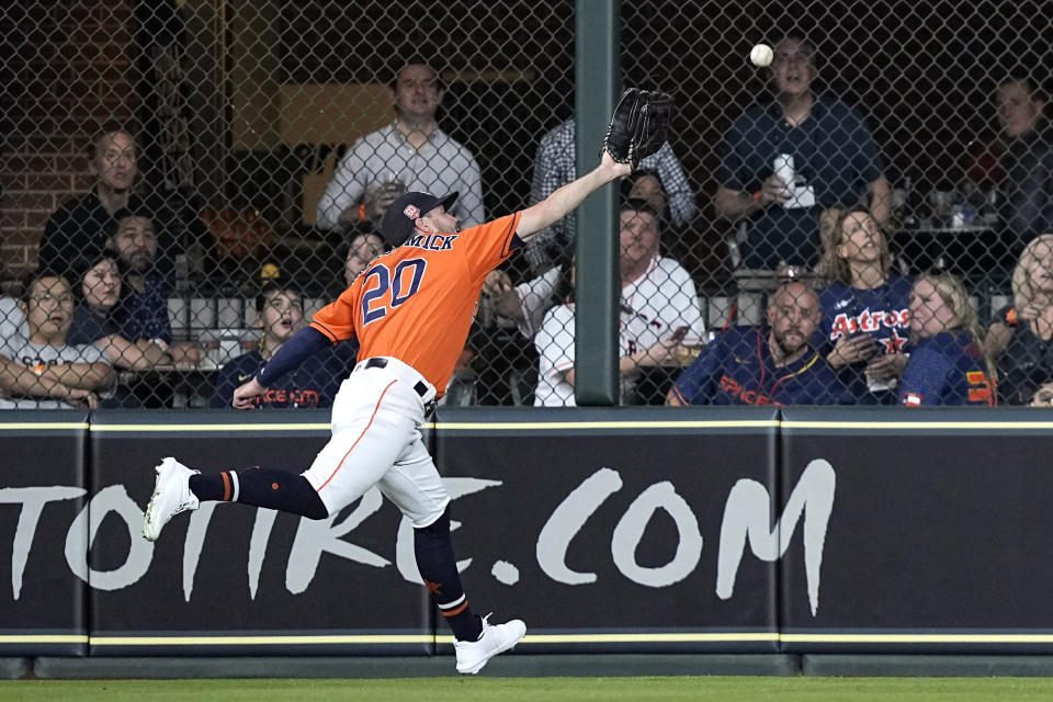 Houston Astros center fielder Chas McCormick reaches for a RBI triple by Tampa Bay Rays' Randy Arozarena during the fifth inning of a baseball game Friday, Sept. 30, 2022, in Houston. (AP Photo/David J. Phillip)