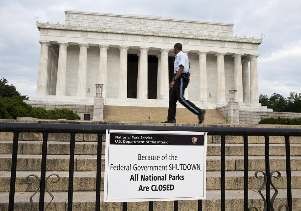 A Park Police officer walks passes a sign announcing the closure of the Lincoln Memorial due to a partial government shutdown in Washington, D.C., on Tuesday, Oct. 1, 2013.  / Credit: Joshua Roberts/Bloomberg via Getty Images