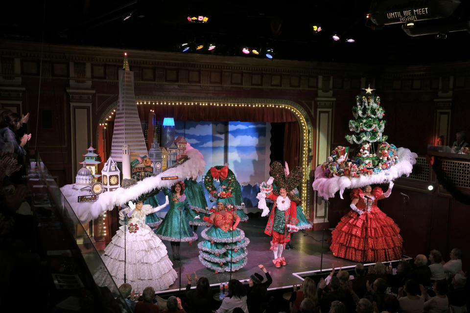 In this Wednesday, Dec. 4, 2019 photo, performers fill the stage for the final number of the musical "Beach Blanket Babylon" in San Francisco. The campy small San Francisco show that's been a must-see for tourists and locals alike for more than 45 years is closing its curtain. The show, which spoofs politics and pop culture, started in 1974, making it the nation's longest continuously running musical revue. Its final performance is set for New Year’s Eve. (AP Photo/Eric Risberg)