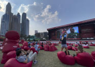 FILE - Soccer fans watch the World Cup Group C soccer match between Argentina and Saudi Arabia on a large screen, at a fan zone in Dubai, United Arab Emirates on Nov. 22, 2022. For a brief moment after Saudi Arabia's Salem Aldawsari fired a soccer ball from just inside the penalty box into the back of the net to seal a win against Argentina, Arabs across the divided Middle East found something to celebrate. (AP Photo/Hussein Malla, File)