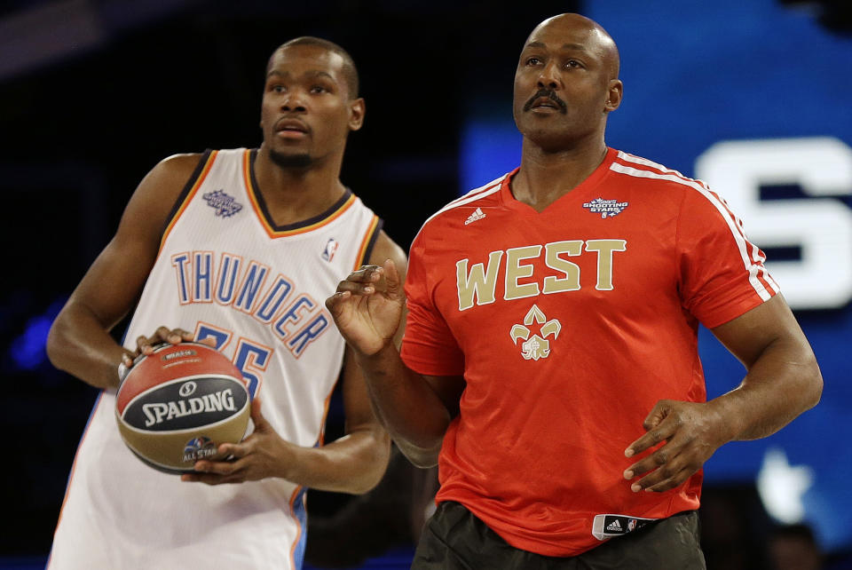 Oklahoma City Thunder Kevin Durant, left and Former player Karl Malone watch a shot on goal during the skills competition at the NBA All Star basketball game, Saturday, Feb. 15, 2014, in New Orleans. (AP Photo/Gerald Herbert)