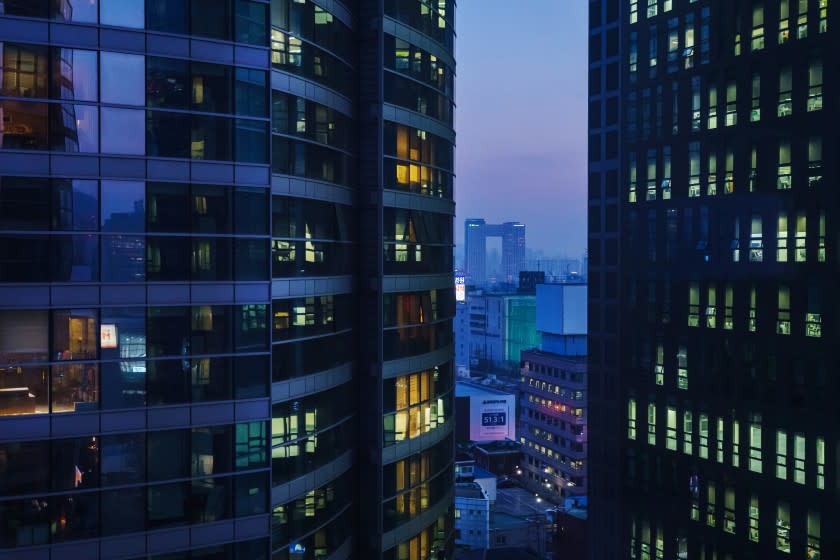 SEOUL, SOUTH KOREA -- MARCH 25, 2021: Apartment buildings light up in the evening as people return home from work in Seoul, South Korea, Thursday March 25, 2021. With noise complaints in high-rise apartments surging amid COVID-19, exasperated South Koreans have turned to extreme measures to avenge their upstairs dwellers.(Marcus Yam / Los Angeles Times)