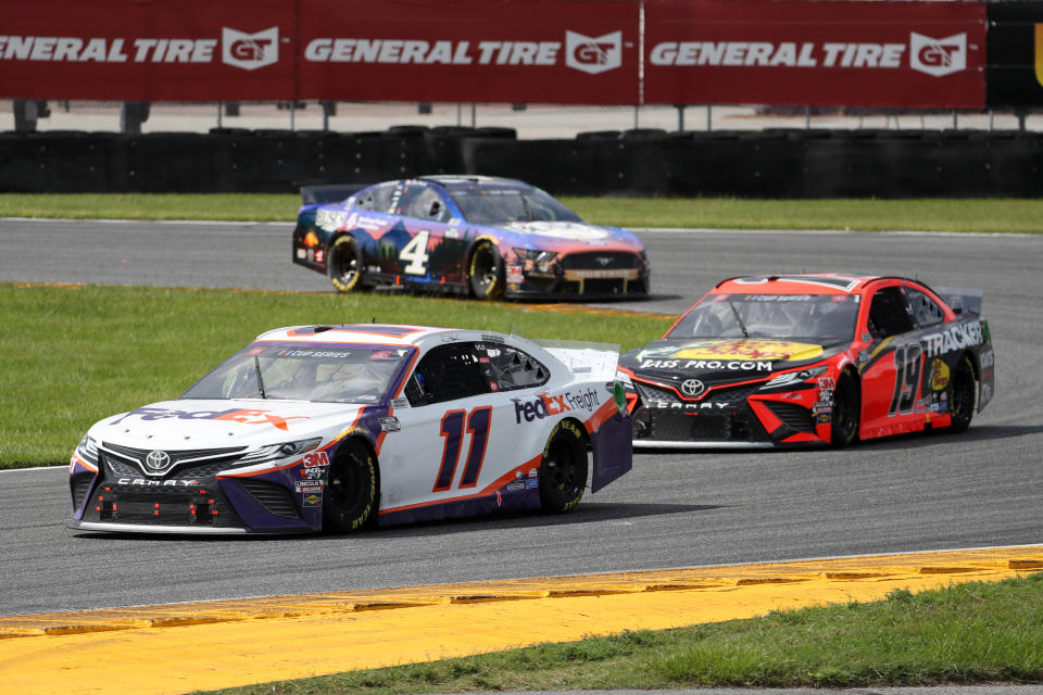 DAYTONA BEACH, FLORIDA - AUGUST 16: Denny Hamlin, driver of the #11 FedEx Freight Toyota, leads Martin Truex Jr., driver of the #19 Bass Pro Shops Toyota, and Kevin Harvick, driver of the #4 Busch Beer National Forest Foundation Ford, during the NASCAR Cup Series Go Bowling 235 at Daytona International Speedway on August 16, 2020 in Daytona Beach, Florida. (Photo by Chris Graythen/Getty Images)