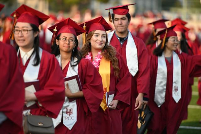 Haley Walters (C) marches with her class at the Pasadena City College graduation ceremony, June 14, 2019, in Pasadena, California. - Haley Walters is five years shy of earning a law degree and, if everything goes according to plan, she should be indebted for $100,000 by the time she enters the work force. Like millions of Americans, Walters, 19, is paying a steep price for an education that will weigh her down financially for much of her adult life. (Photo by Robyn Beck / AFP)        (Photo credit should read ROBYN BECK/AFP via Getty Images)