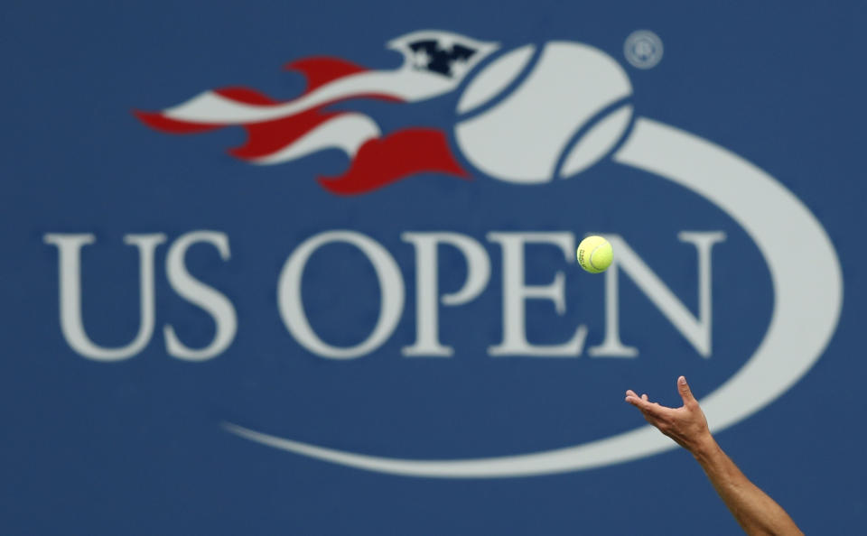 FILE - In this Sept. 2, 2017, file photo, Philipp Kohlschreiber, of Germany, serves to John Millman, of Australia, during the third round of the U.S. Open tennis tournament in New York. A high-ranking official for the U.S. Open tells the Associated Press that if the Grand Slam tennis tournament is held in 2020, she expects it to be at its usual site in New York and in its usual dates starting in August. (AP Photo/Adam Hunger, File)